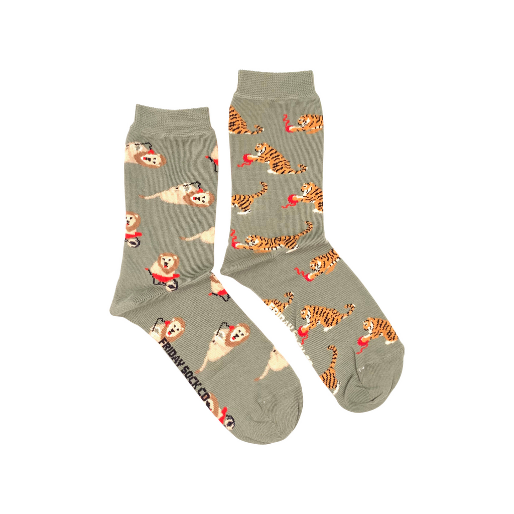 green socks with lions and tigers playing with red yarn