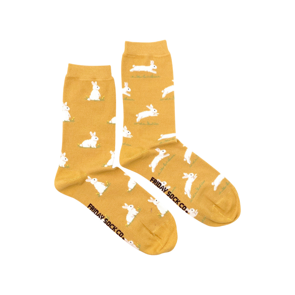 golden yellow mismatched women's socks with white bunnies on them