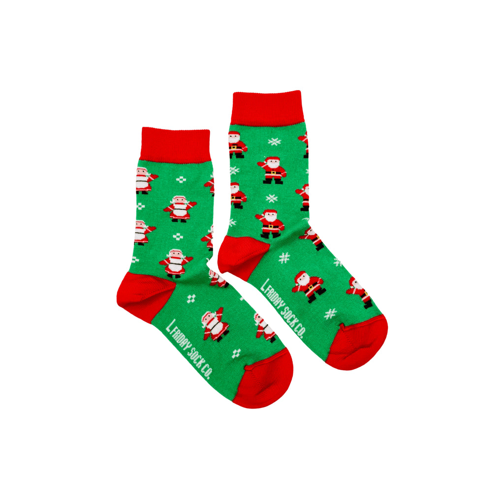 Kids’ mismatched Christmas socks featuring Santa designs – festive and fun for the holidays.