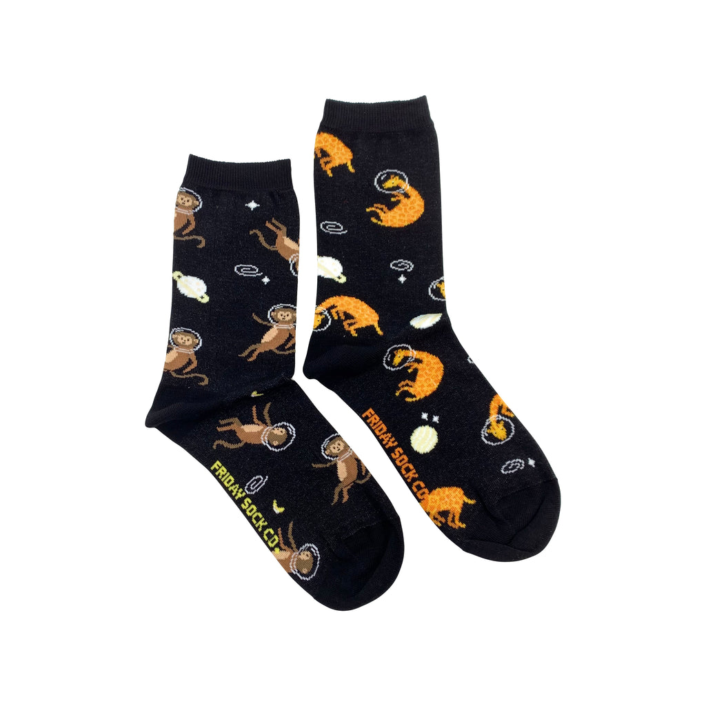 black socks with monkeys and giraffes wearing space helmets in outer space