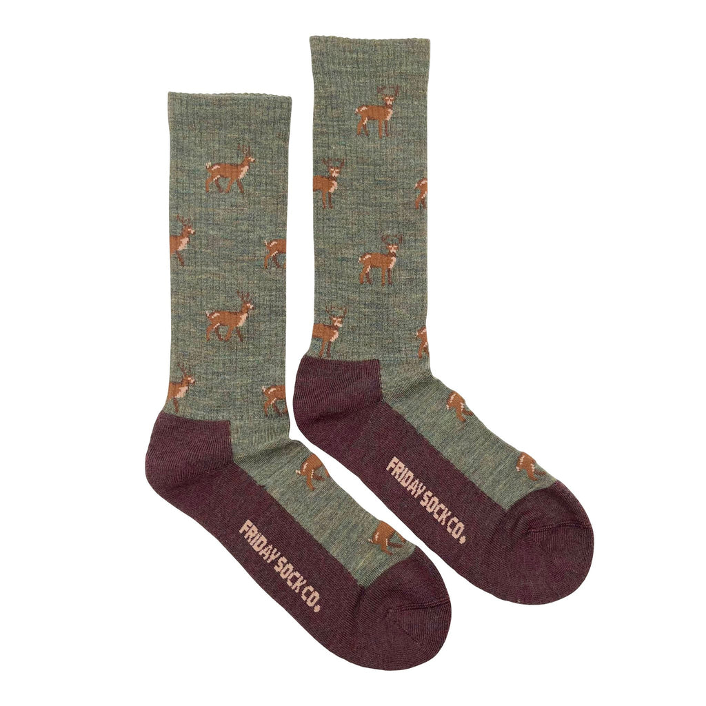 green wool socks with brown sole and deer pattern